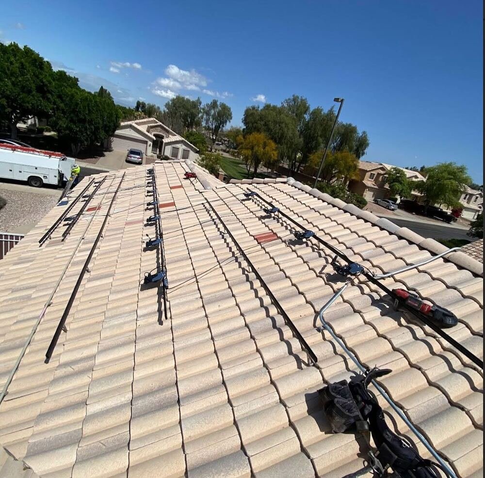Solar mounting rails being installed on tile roof